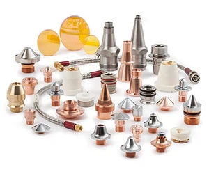 Assorted laser consumables including nozzles, lenses, and protective windows used in laser cutting systems